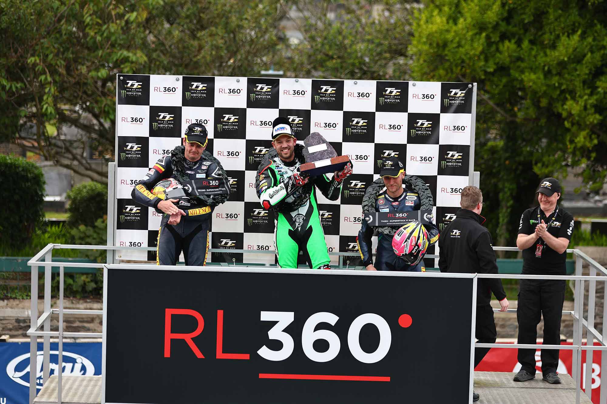 The final hardware won: Peter Hickman hoists the Senior TT trophy, alongside Padgett teammates, Conor Cummins and Davy Todd, 2nd and 3rd place, respectively.