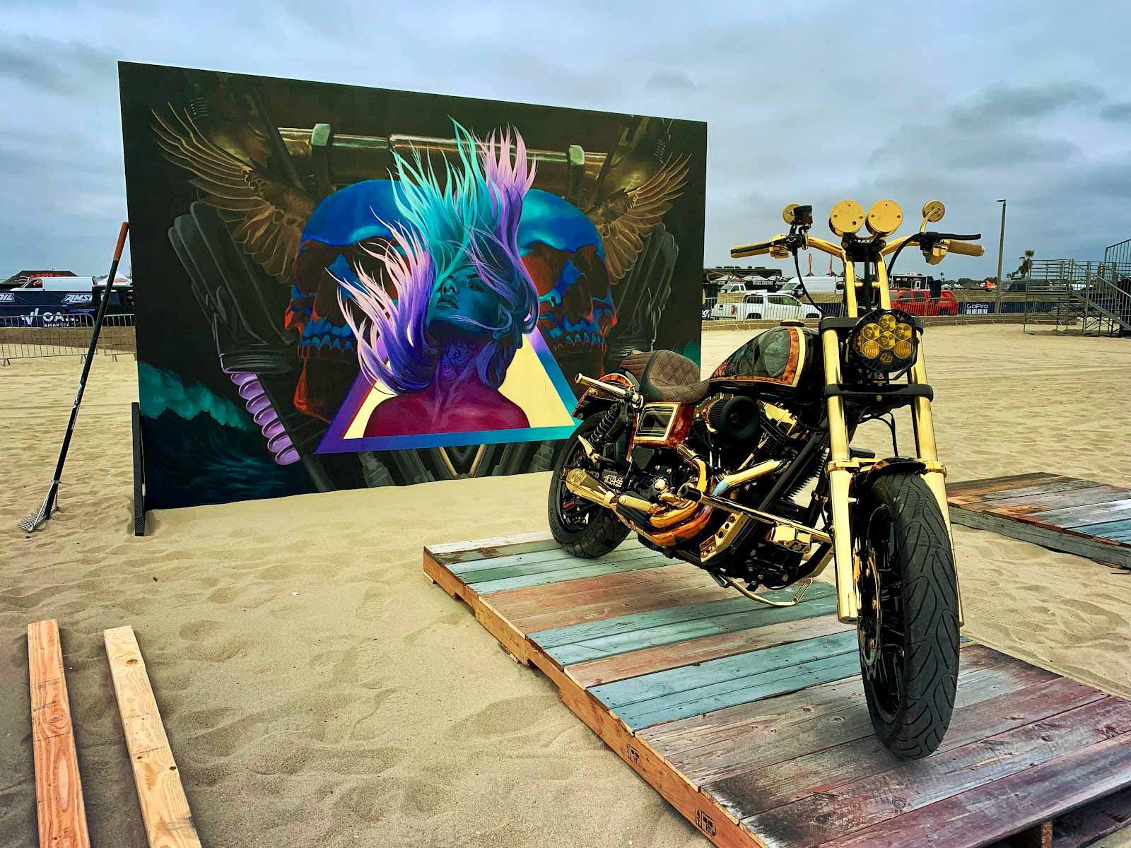 Stunning artistic pairing of Melany Meza-Dierk’s painting and Trev Dogg’s custom Dyna; photo taken during setup on Friday.
